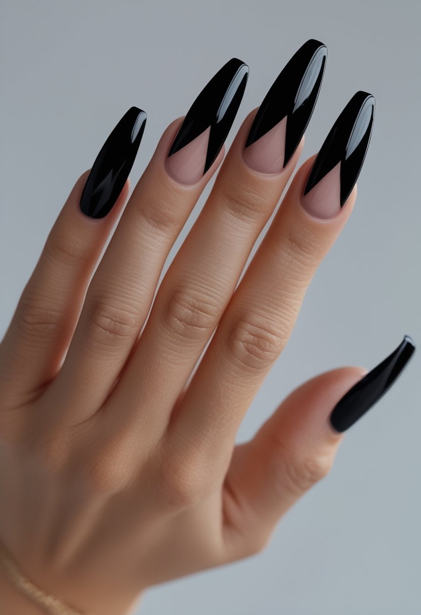 A hand displays long black French stiletto nail extensions against a neutral background.