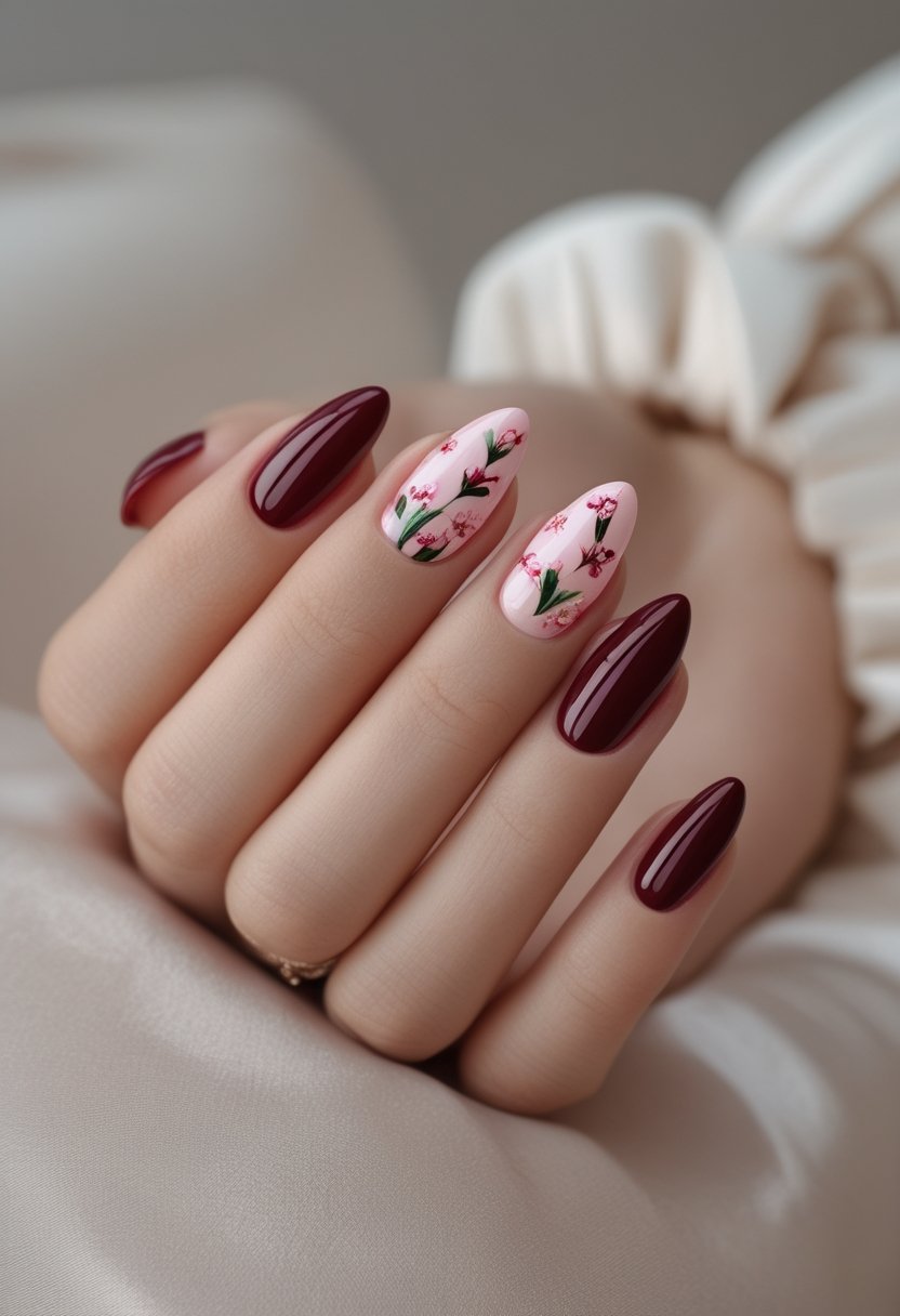 Pink And Red Nail Designs: 15 Stunning Looks To Try Now A manicured hand displays deep red nails decorated with delicate pink floral designs.
